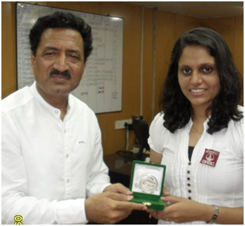 Pooja displaying her medal and sharing few moments of the C'ship with Mr V.K. Mahendru, Head Sports